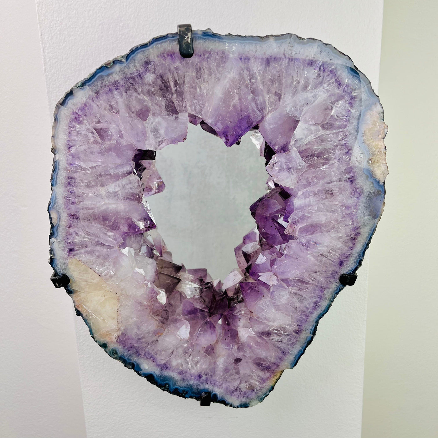 Frontal view of Amethyst Cluster with Calcite Mirror, mounted on a wall