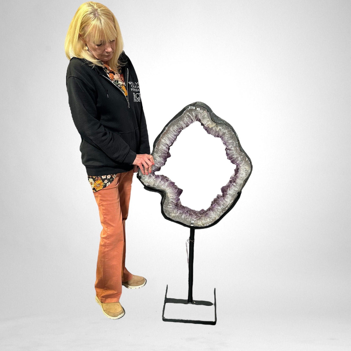 woman next to Large Amethyst Portal on Metal Stand on white background for size reference