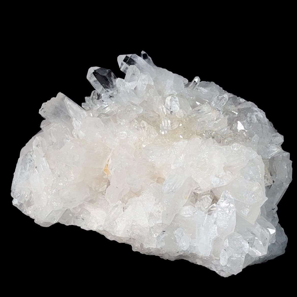 Frontal view of Rough Crystal Quartz Large Cluster on a velvet black surface.