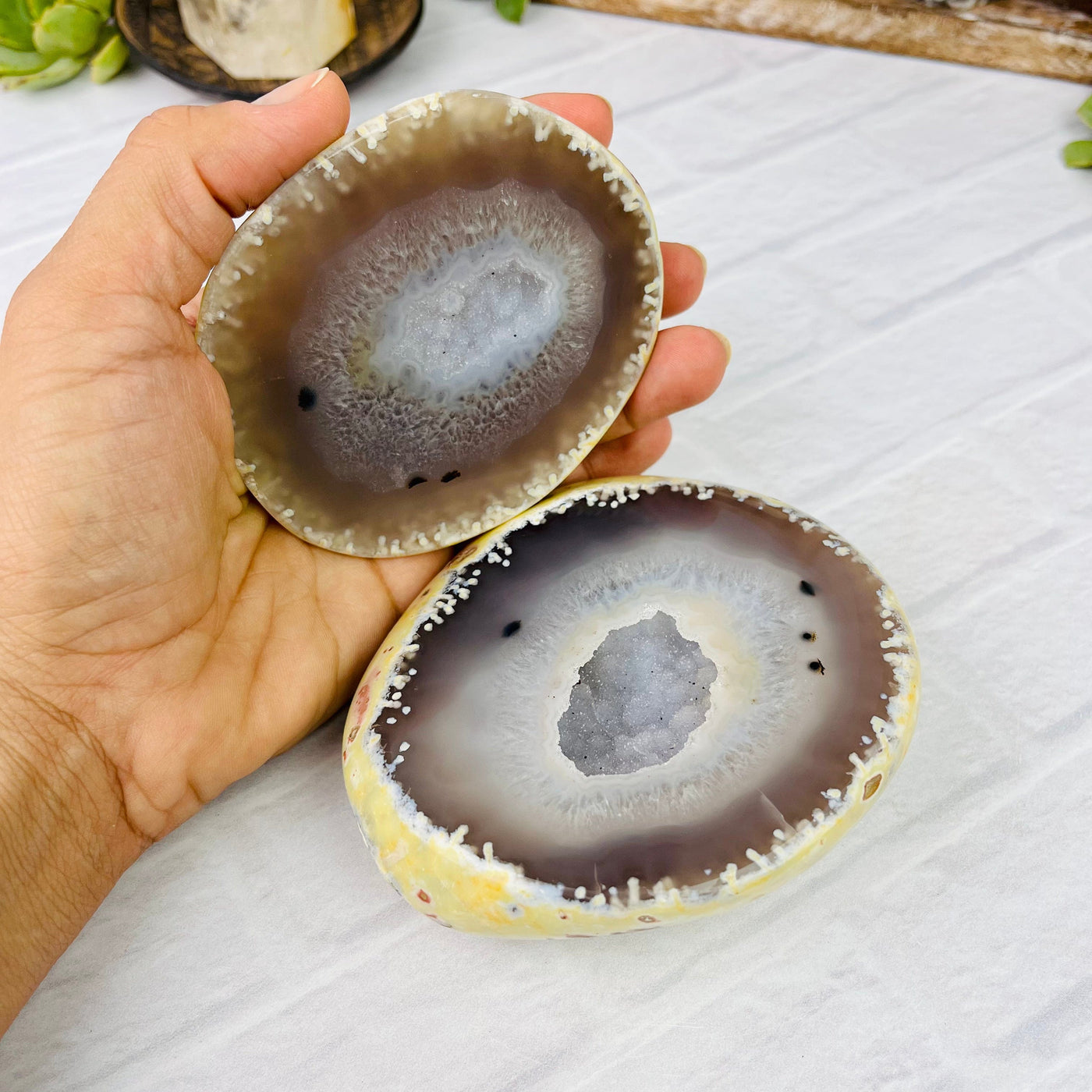 Aerial view of Speckled Agate Druzy Geode Box, held open by female hand.