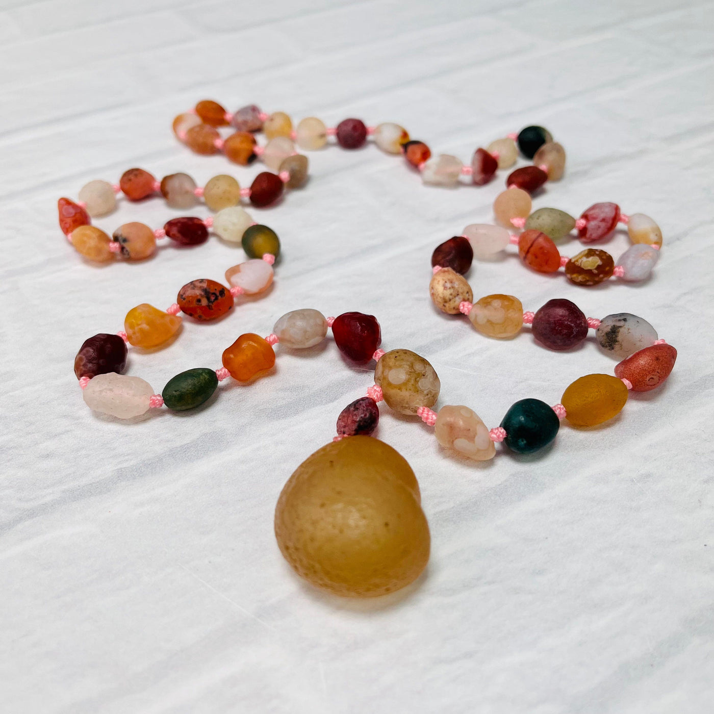 Gobi Desert Agate Bead Necklace laid out on a white surface.