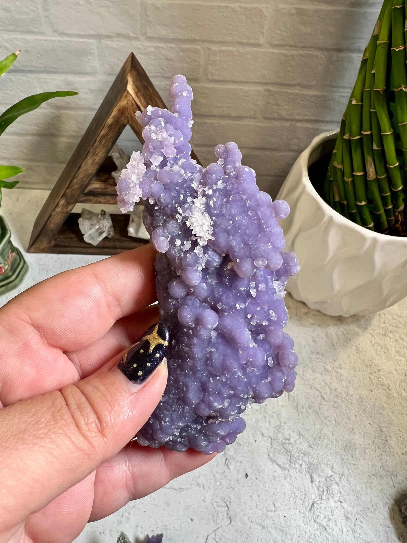 Grape agate formation in a woman's hand.