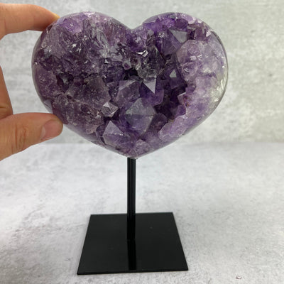  Amethyst Heart Cluster on Metal Stand - OOAK - with finger for size reference 