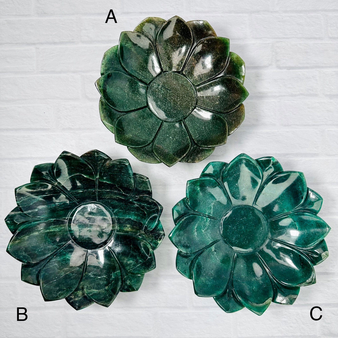 Aerial view of 3 Green Quartz Lotus Bowls with their respective letter next to them.