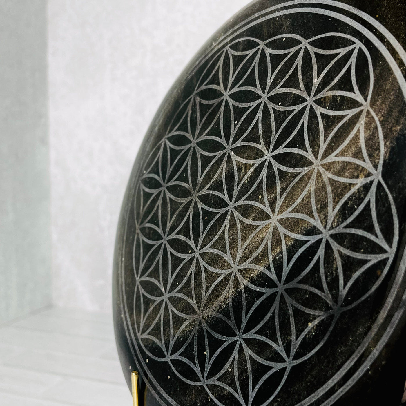 Up close angled frontal view of Gold Sheen Obsidian Flower of Life Plate.