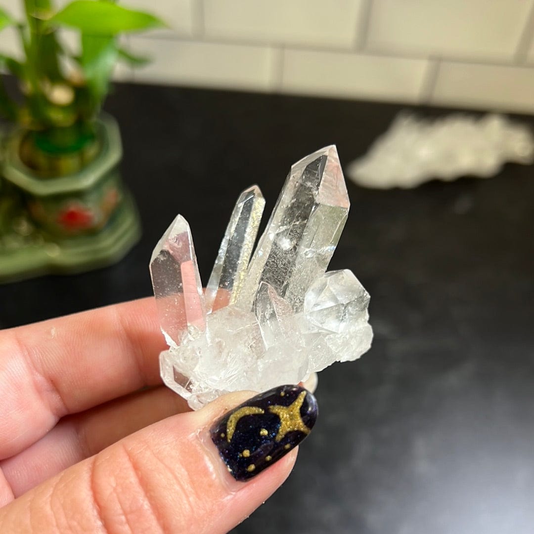 Crystal Quartz Cluster held in a woman's hand.