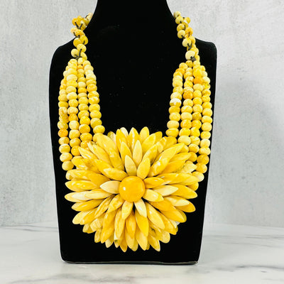 Frontal view of Yellow Baltic Amber Beaded Flower Necklace shown on a bust display.