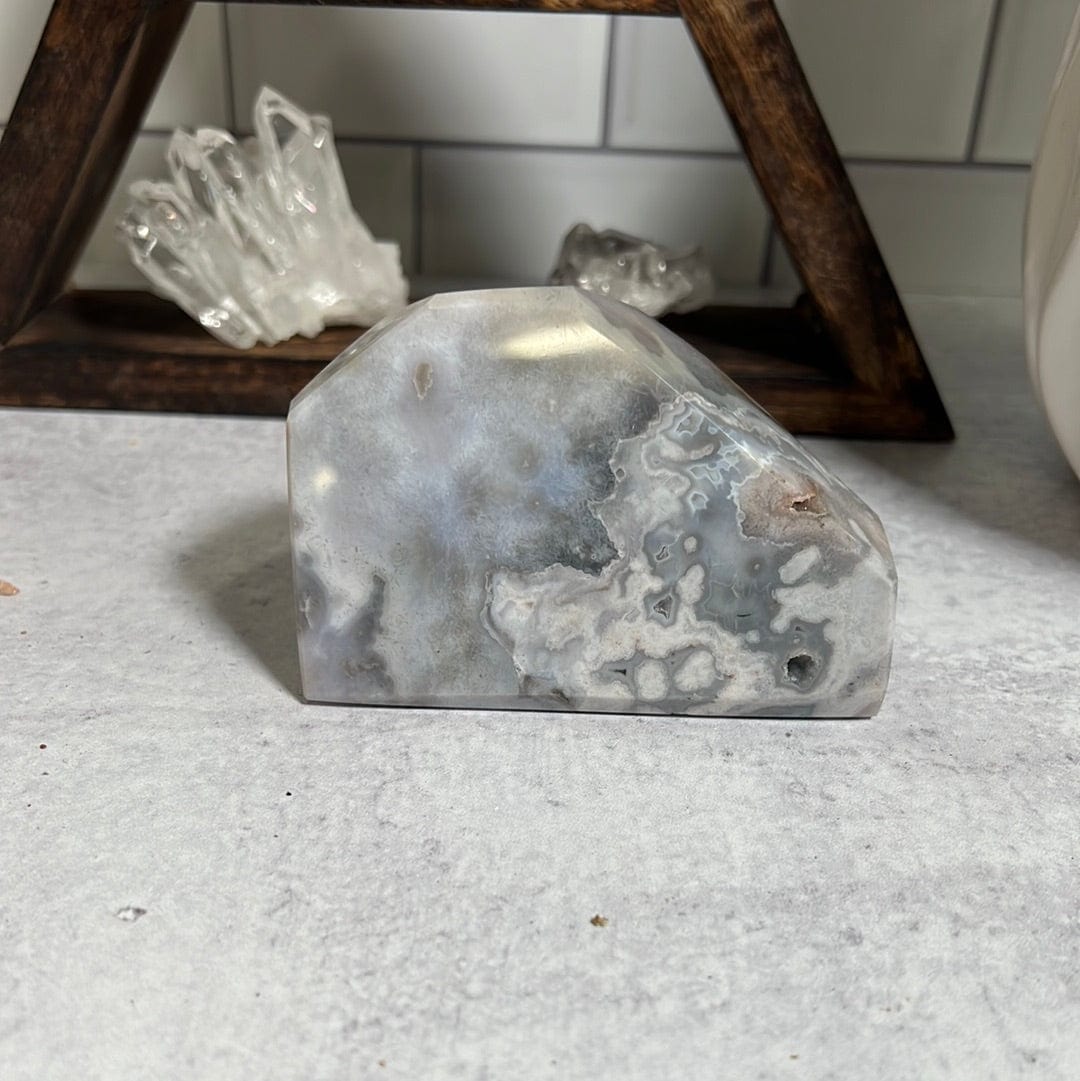 Cut base agate with that is polished and sits flat.  It is shades of gray and white.