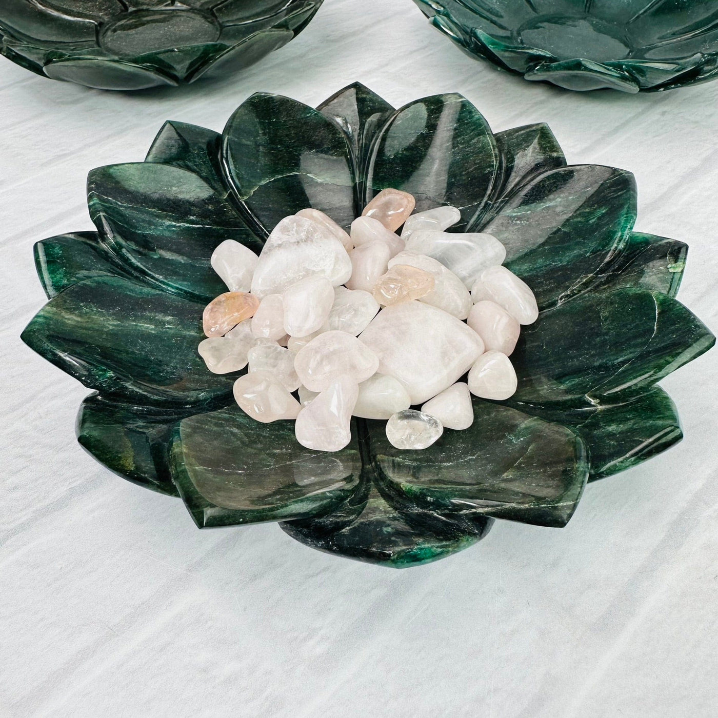 Up close view of Green Quartz Lotus Bowl with small white stones inside.