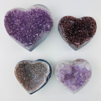 4 Amethyst Crystal Gemstone Hearts on a white background for you to choose