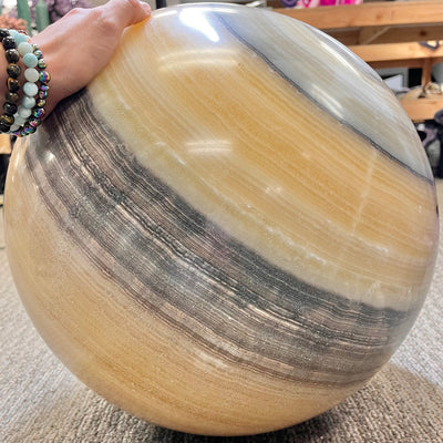 Tilted view of Mexican Onyx - Colossal Polished Sphere Option A.