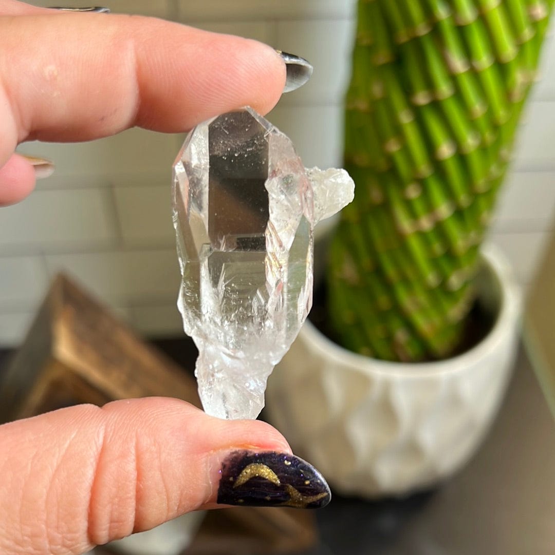 Crystal Quartz Cluster in a woman's hand.
