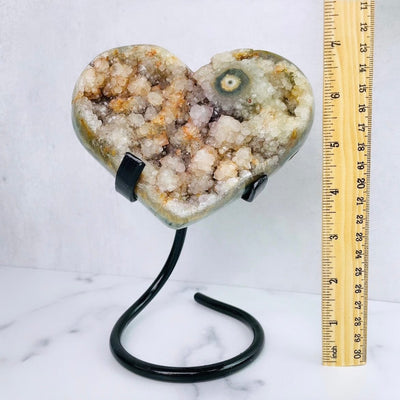 Frontal view of Amethyst Druzy Heart with Stalactite on Metal Stand, pictured next to a ruler for sizing reference