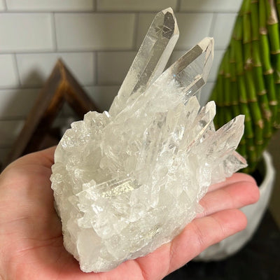 Crystal cluster in a woman's hand.