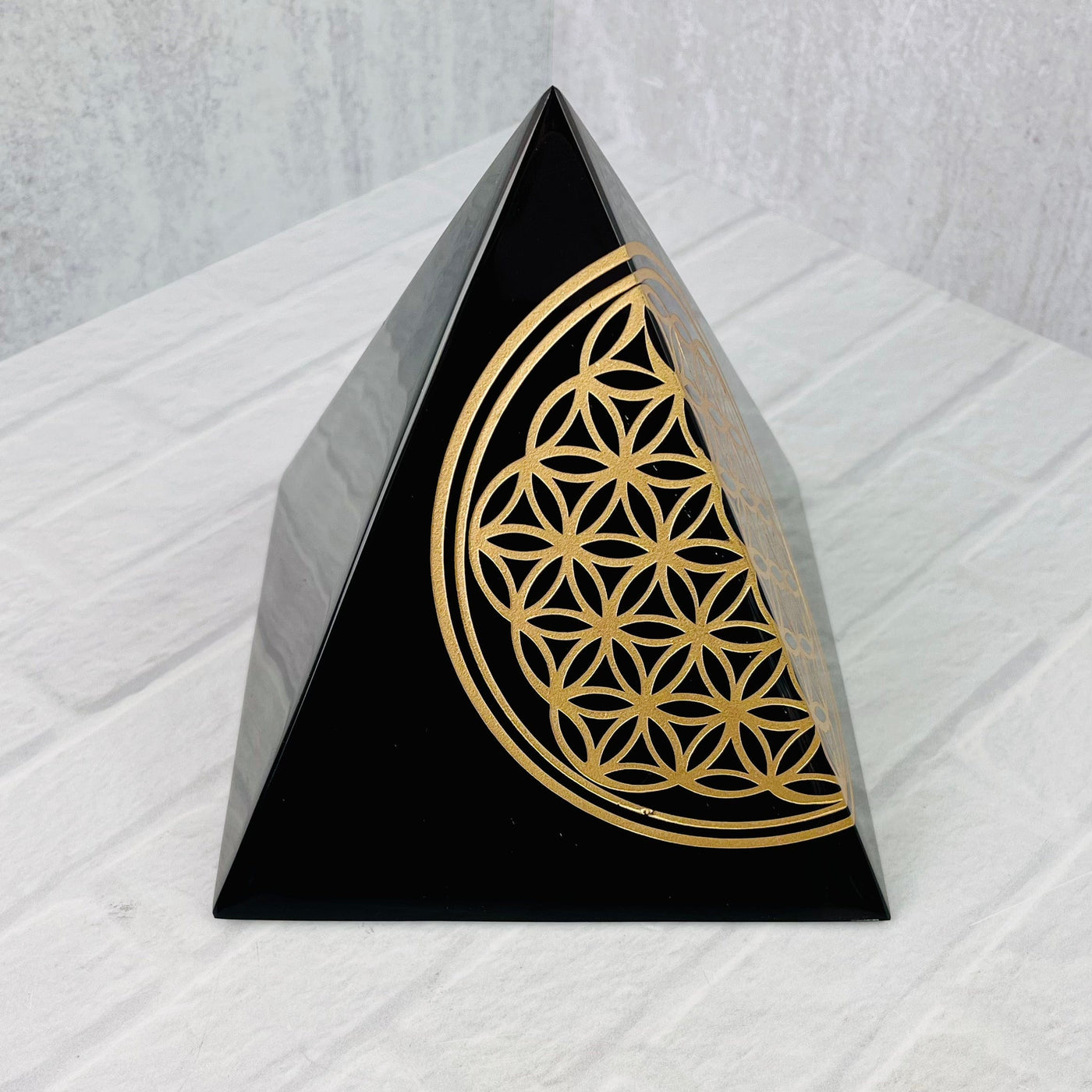Angled aerial view of Gold Sheen Obsidian Flower of Life Pyramid.
