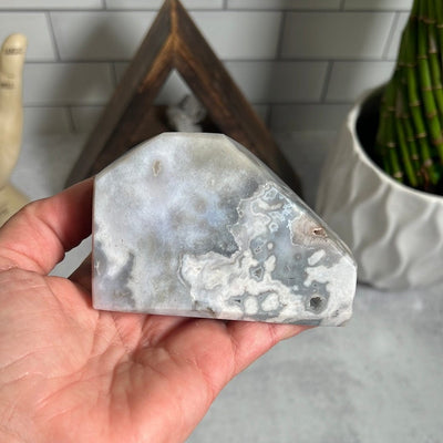 Cut base agate with that is polished and sits flat.  It is shades of gray and white.