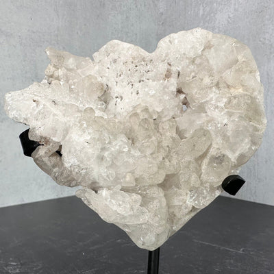Up close frontal view of Crystal Quartz Abstract Heart on Metal Stand positioned in a different angle.