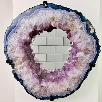 Amethyst Point Mirror pictured mounted on a wall