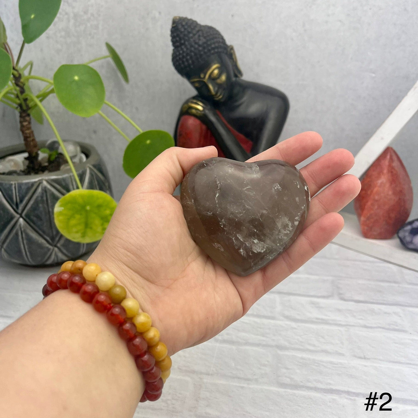 Smokey Quartz Polished Puff Hearts - front view of choice number two in hand for size reference