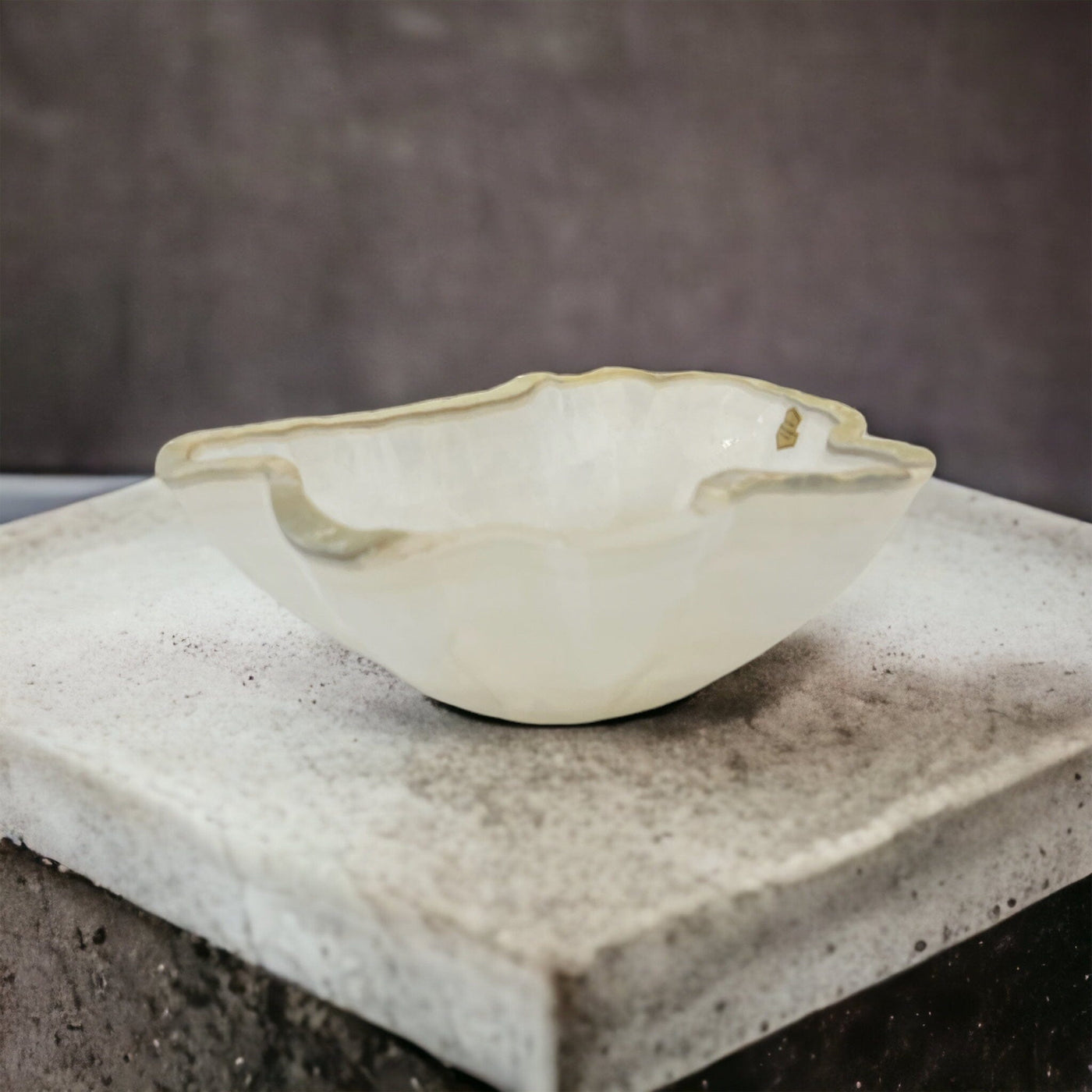 Light colored Mexican onyx bowl on a gray background.