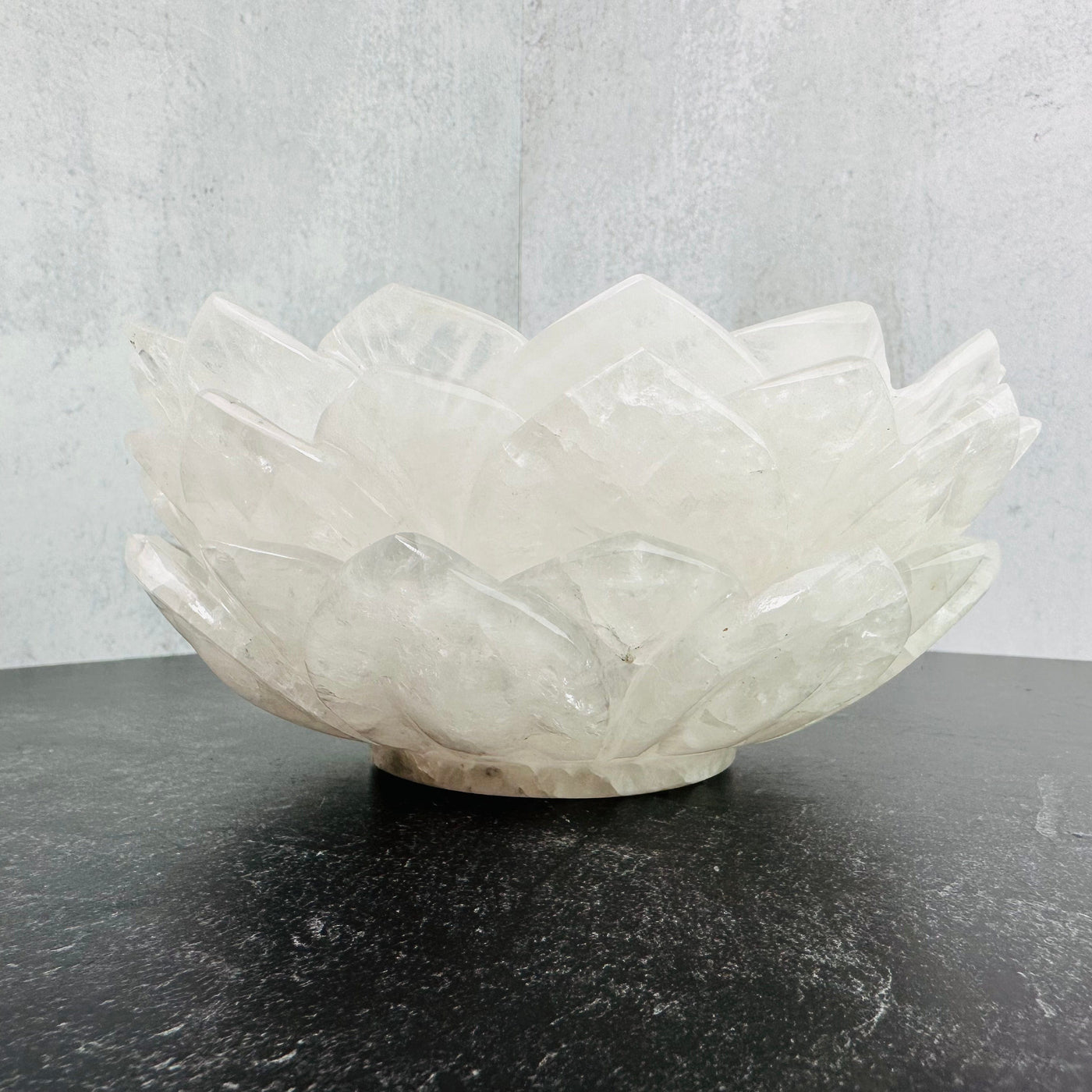 3 Crystal Quartz Lotus Bowls stacked on a black surface.