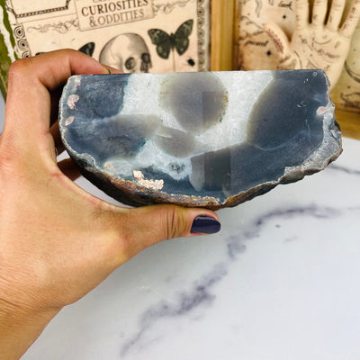 View of bottom of Agate Cut Base with Amethyst, held in hand