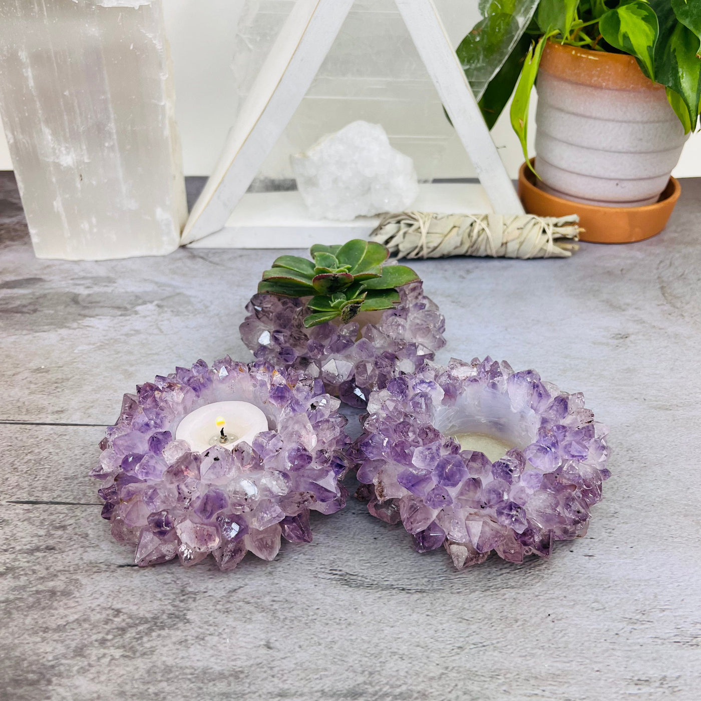 3 Amethyst Point Candle Holders on a table from a side view