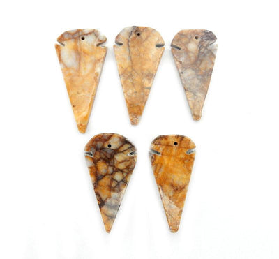multiple jasper arrowhead beads displayed to show the differences in the color shades 