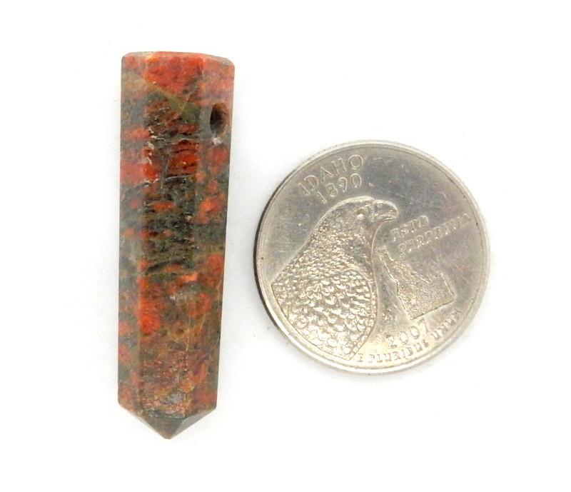 Jasper  Pencil Point Bead next to a quarter for size reference