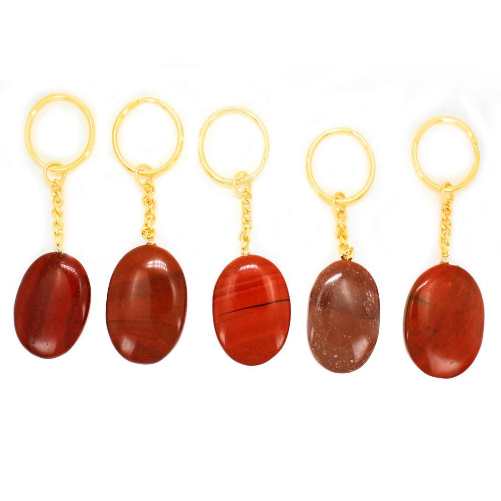 5 Red Jasper Worry stone Keychains lined up on white background
