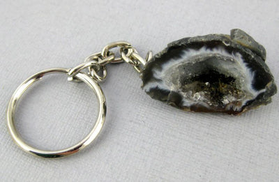 Close up of one Agate Geode Keychain  on a light colored background.