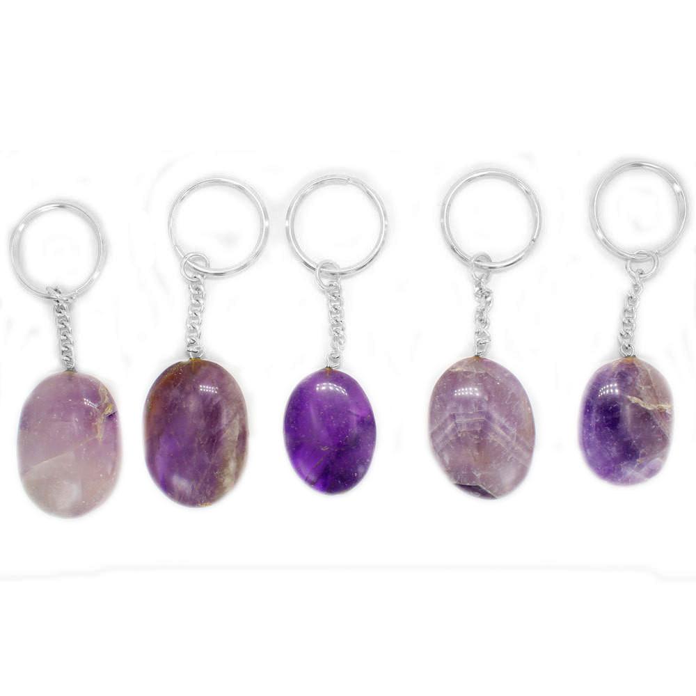 multiple amethyst worry stones displayed to show the differences in the color shades 