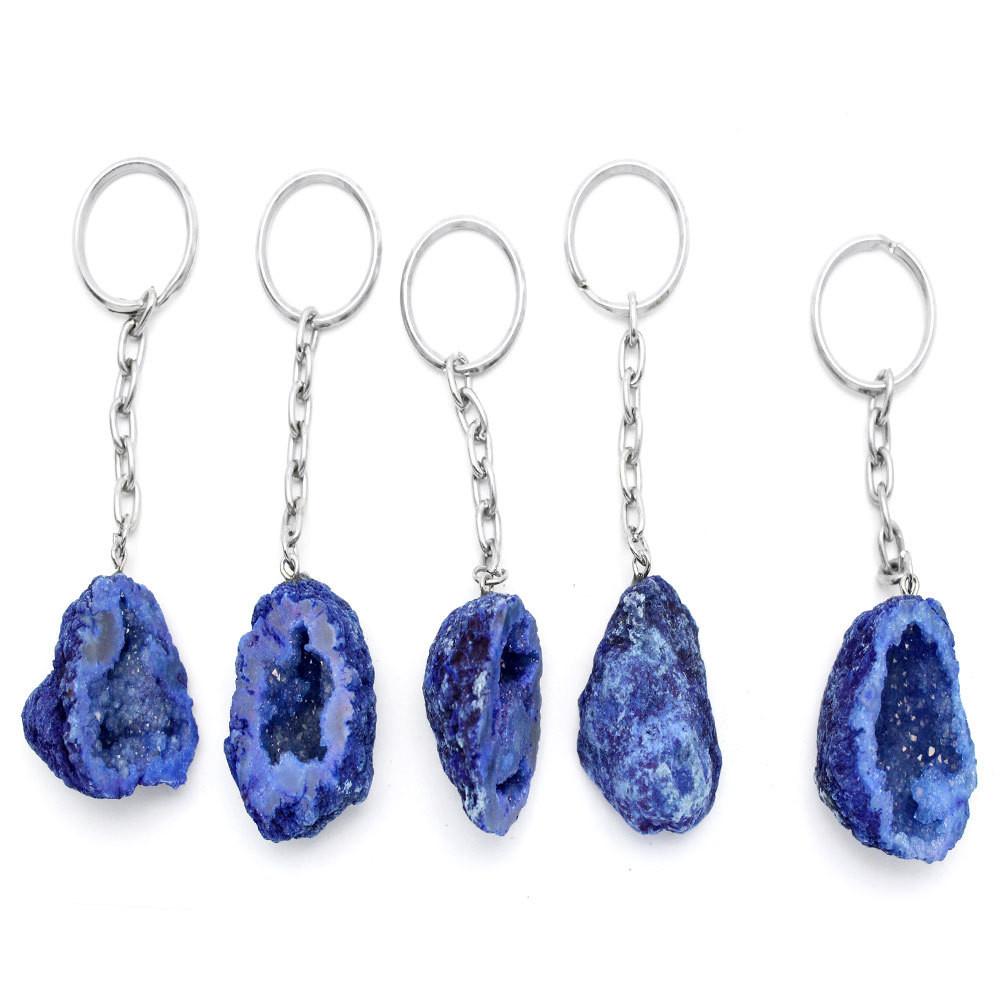 colored half occo geode silver toned keychains shown against a white background