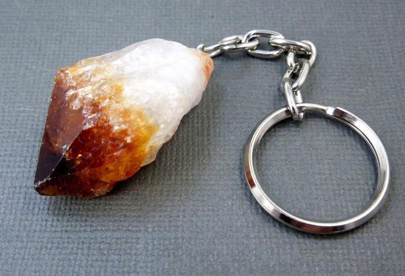 Single Citrine Keychain close up view on a grey background