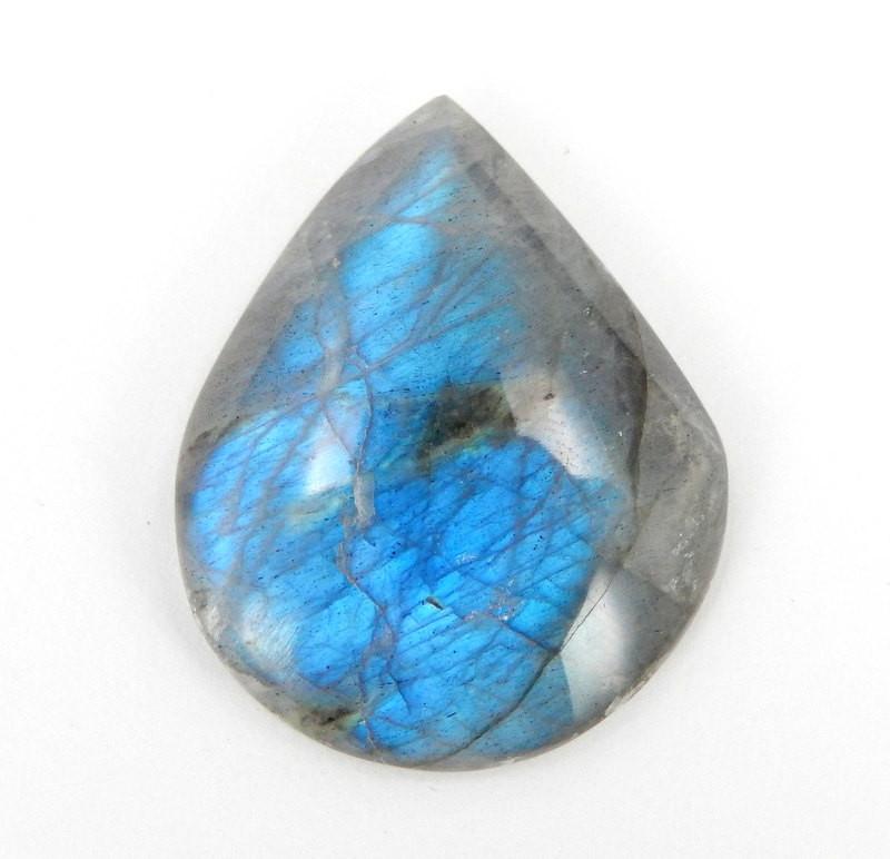 up close of labradorite teardrop cabochon showing natural inclusions and luminessence