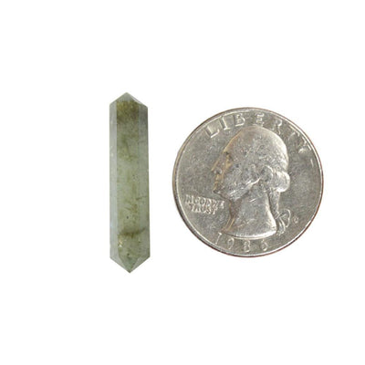 labradorite pencil points next to a quarter