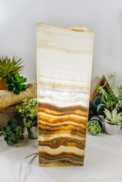 Mexican Onyx Tall Squared Lamp lit up with decorations in the background