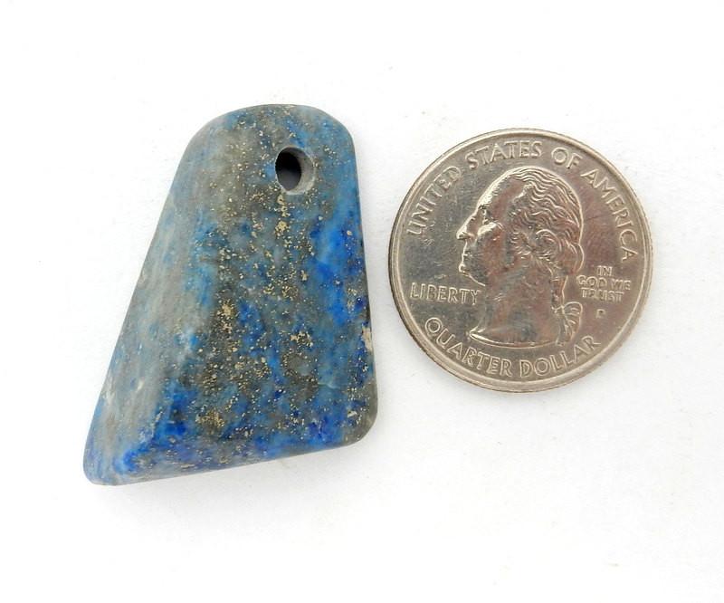 Tumbled lapis lazuli bead next to quarter for size reference