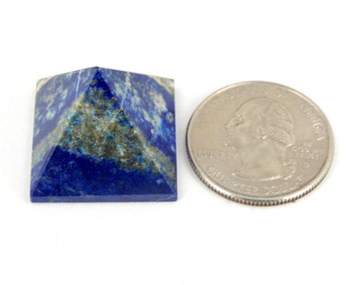 lapis pyramid next to a quarter