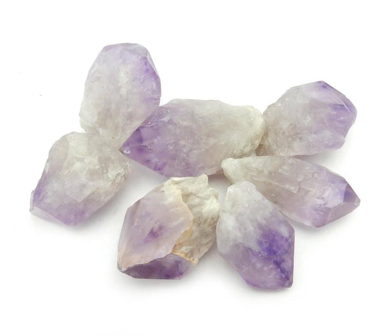 7 large amethyst points on white background