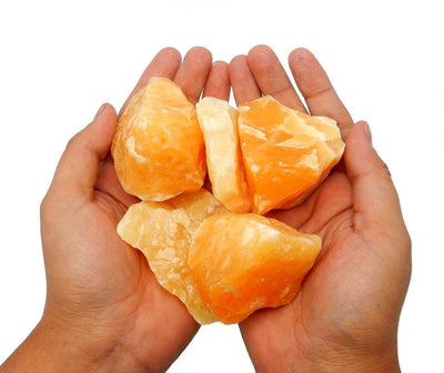 Orange Calcite Stone - 4 stones in 2 hands together