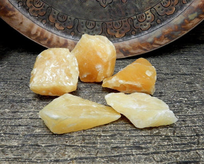 Orange Calcite Stone - 5 pieces on a table