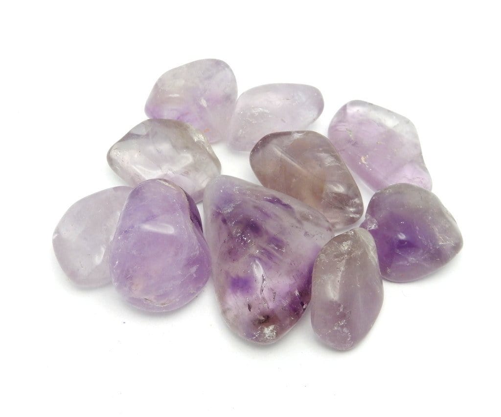 tumbled amethyst stones in a pile