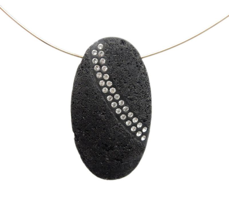 oval lava rock bead with rhinestones on a gold wire on white background