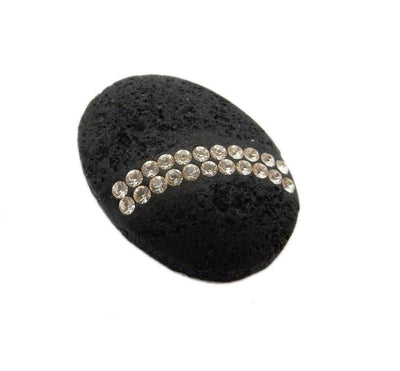 Oval lava stone with two rows of white rhinestones curved across the bottom.