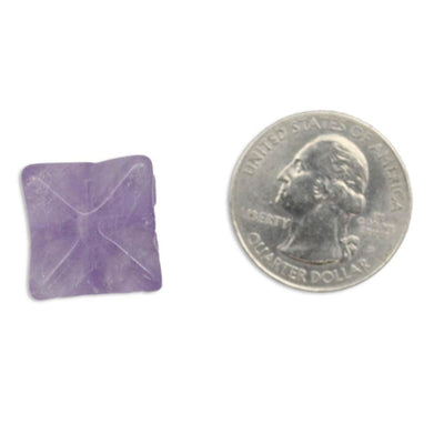 Merkaba Star Amethyst on a white background.  Next to a quarter showing it is around the same size.