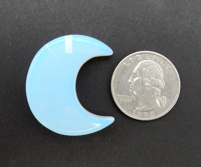 Opalite Half Crescent Moon - Drilled displayed next to a quarter for size reference.
