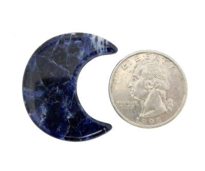Blue Sodalite Half Crescent Moon - Drilled, displayed next to a quarter for size reference.