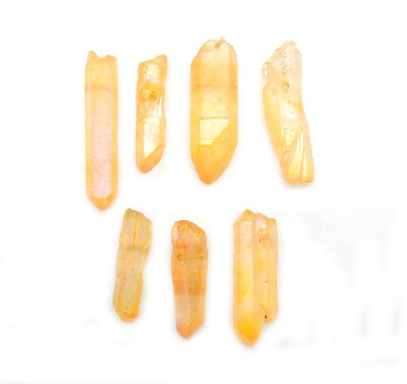 multiple Mystic Orange Titanium Treated Quartz Point Beads displayed to show various lengths and formations