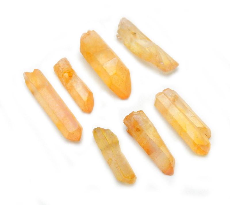 side view of multiple Mystic Orange Titanium Treated Quartz Point Beads for thickness reference